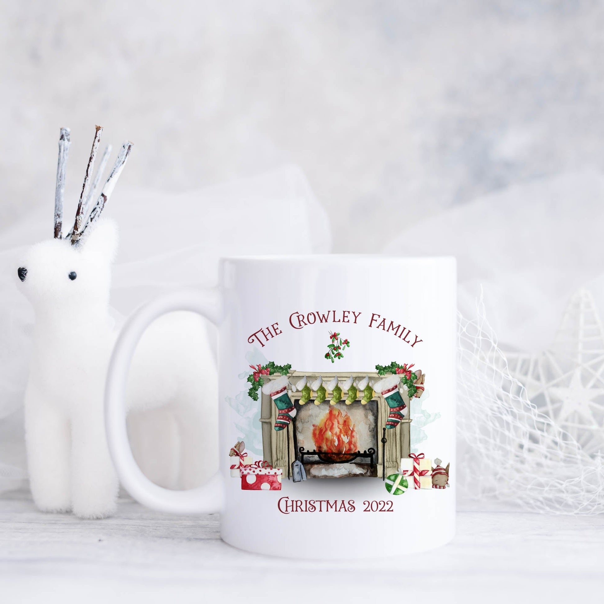 Ceramic mug featuring a traditional fireplace, green and red stockings, cute mice and wrapped gifts with personalised text