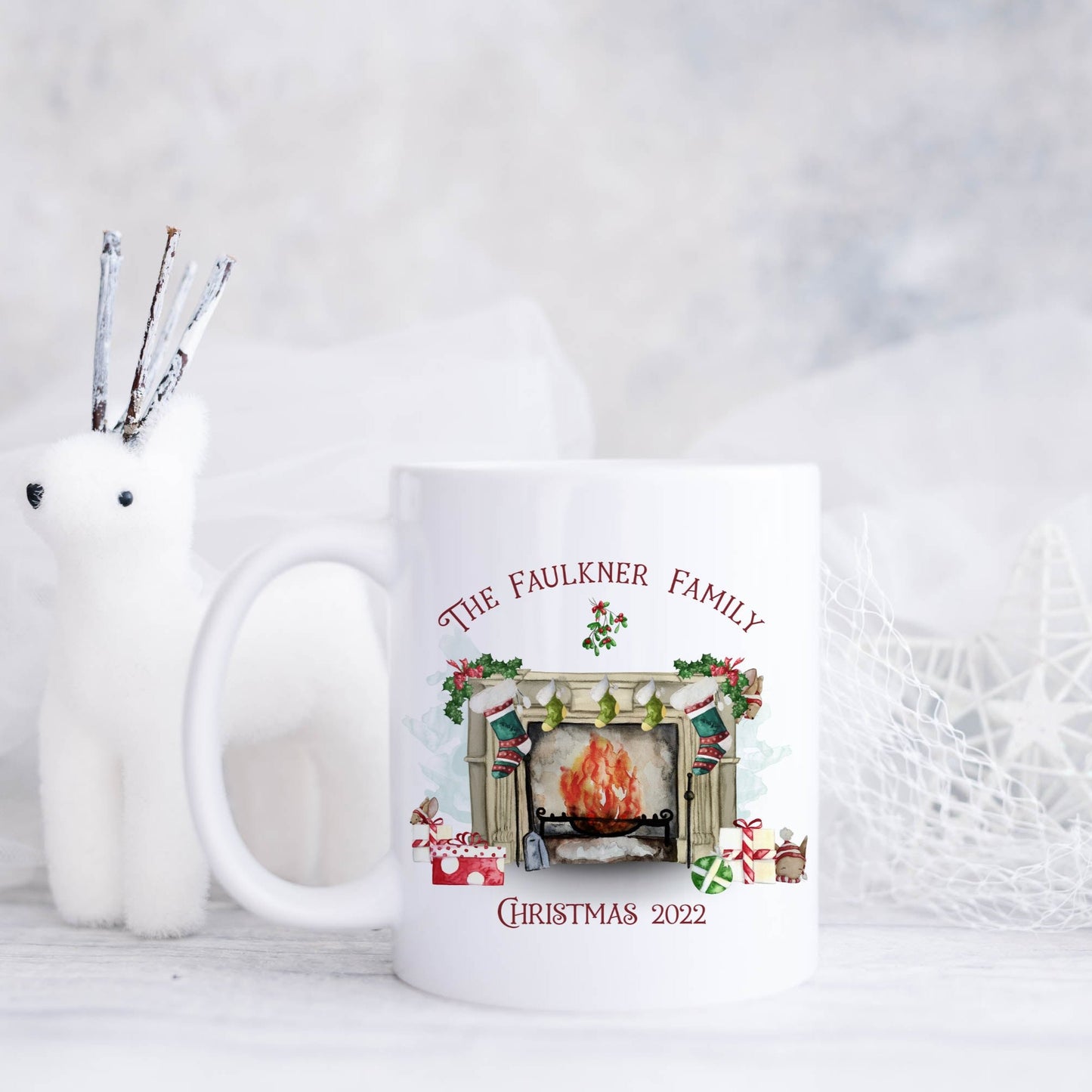 Ceramic mug featuring a traditional fireplace, green and red stockings, cute mice and wrapped gifts with personalised text