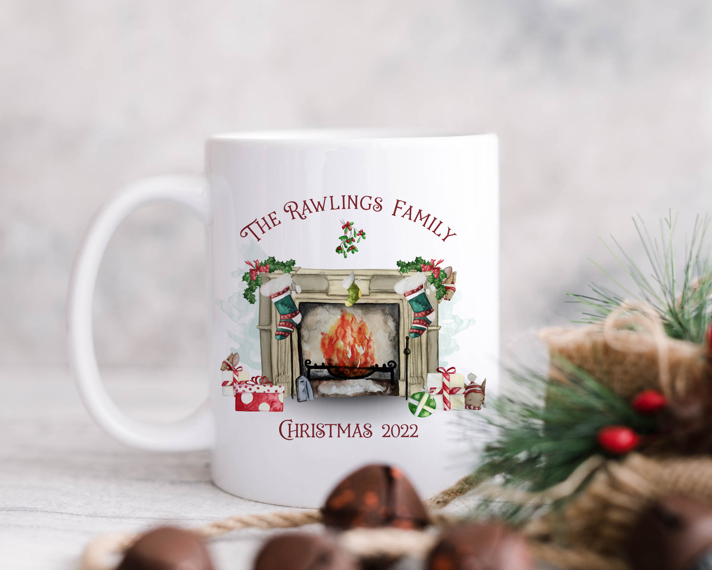 Ceramic mug featuring a traditional fireplace, green and red stockings, cute mice and wrapped gifts with personalised text