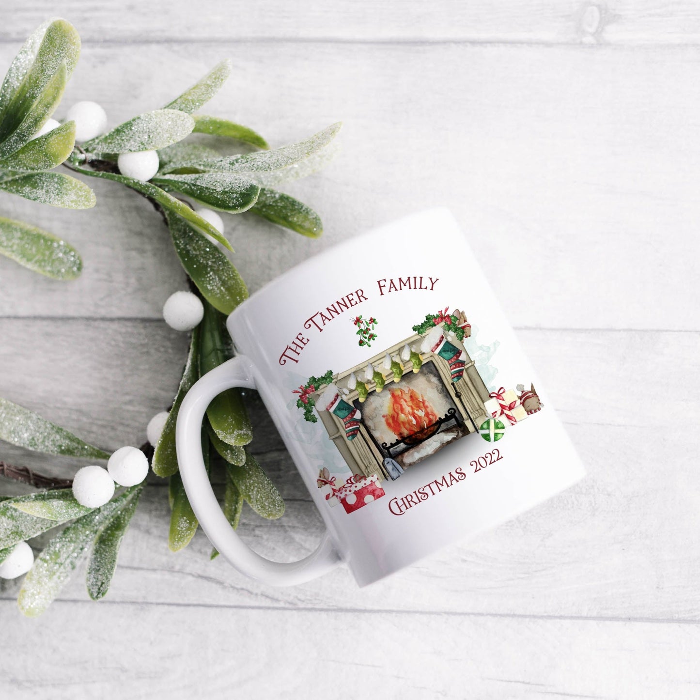 Ceramic mug featuring a traditional fireplace, green and red stockings, cute mice and wrapped gifts with personalised text